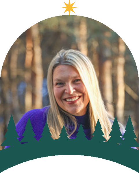 Kim Kluge, framed in the North Point Grants arch with a gold star and pine treeline